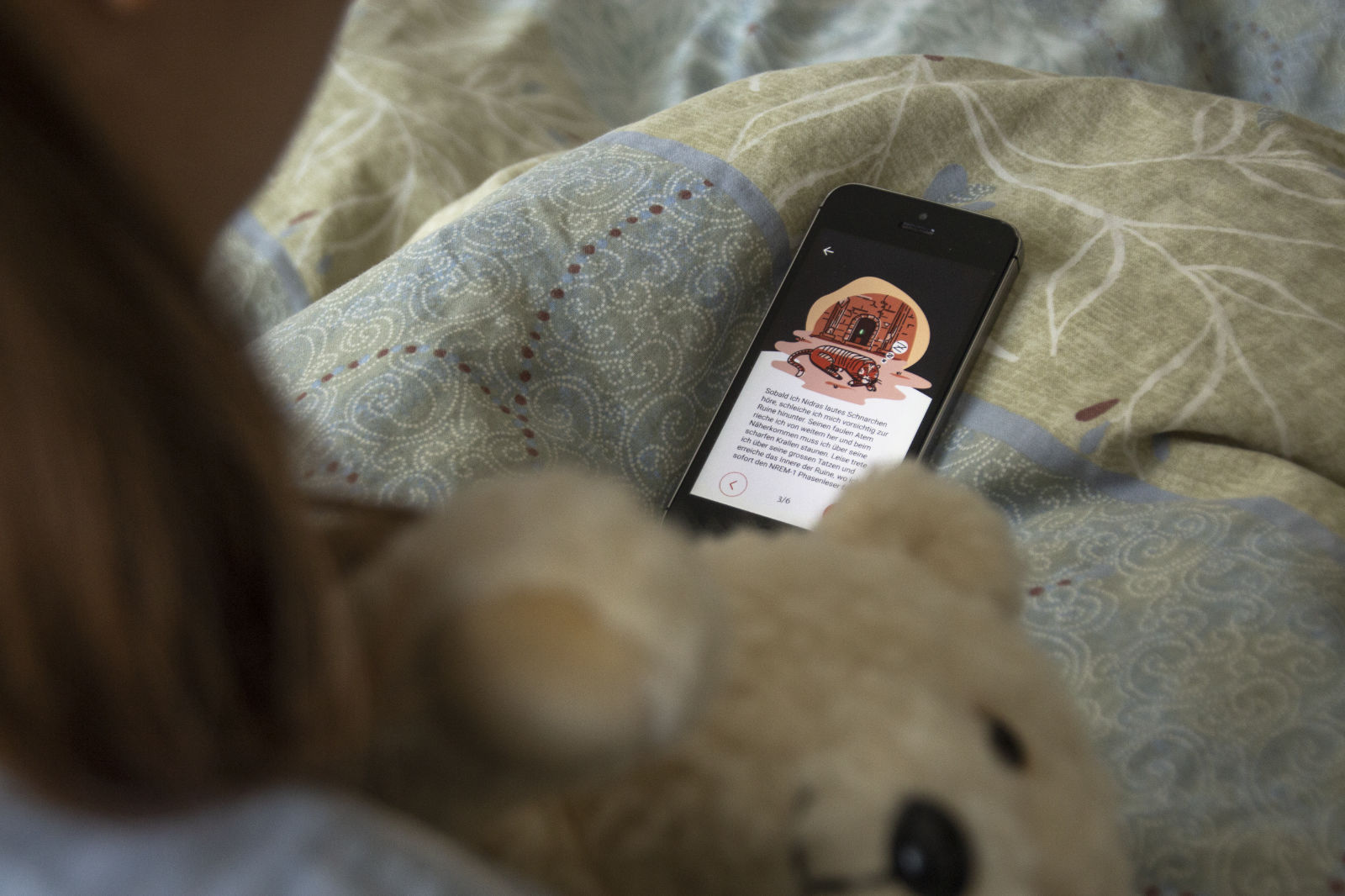 Child looking at app in bed